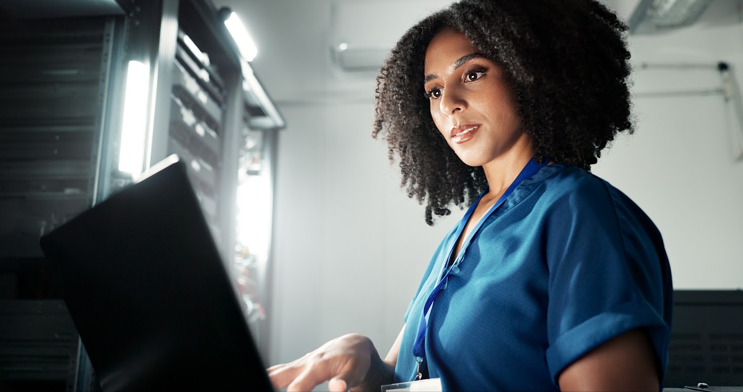 Therapist looking at a laptop while doing ai medical scribe implementation