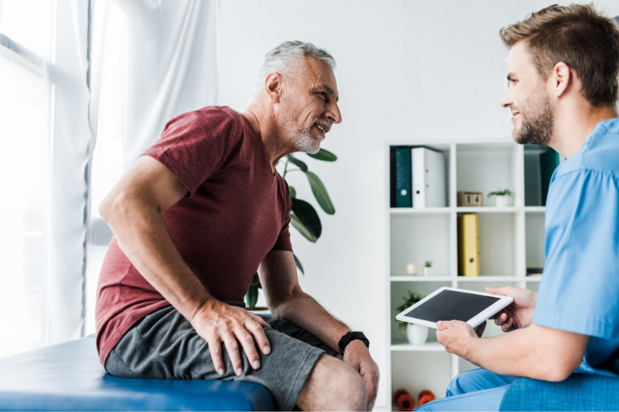 cheerful patient looking at physical therapist