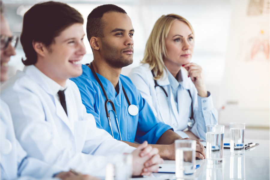 Healthcare professionals discussing AI-powered solutions for healthcare documentation and AI integration strategies for EMRs in a clinical setting.